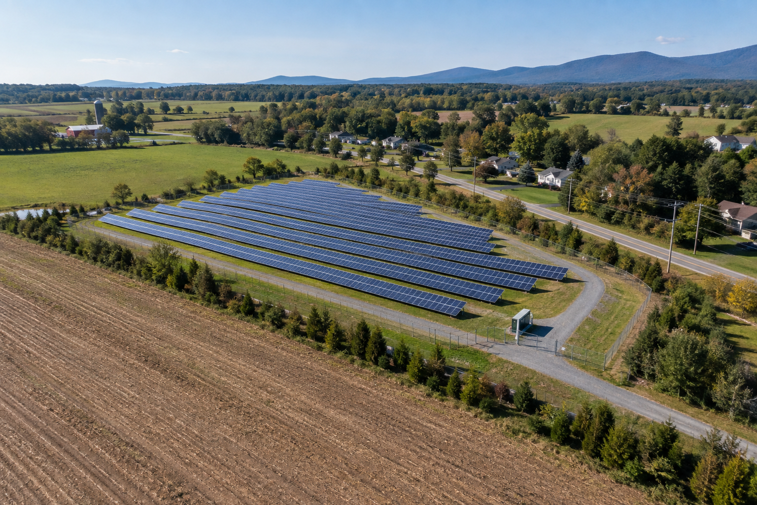 Illustrative community solar project beside farmland and a nearby community